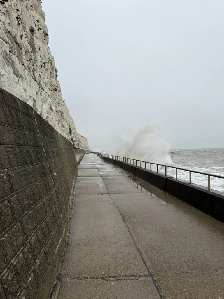 Waves breaking over the undercliff walk