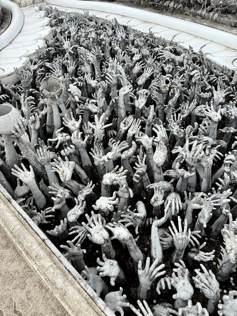 The hands reaching up at the entrance