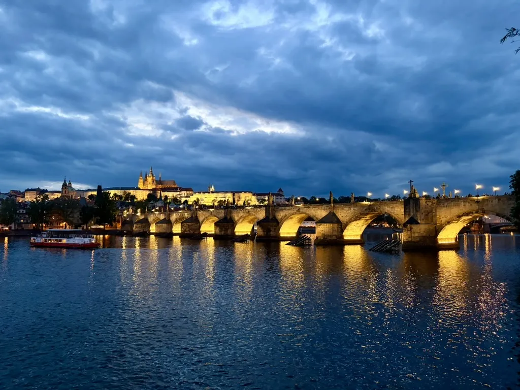 Charles Bridge at night, with Prague Castle behind it